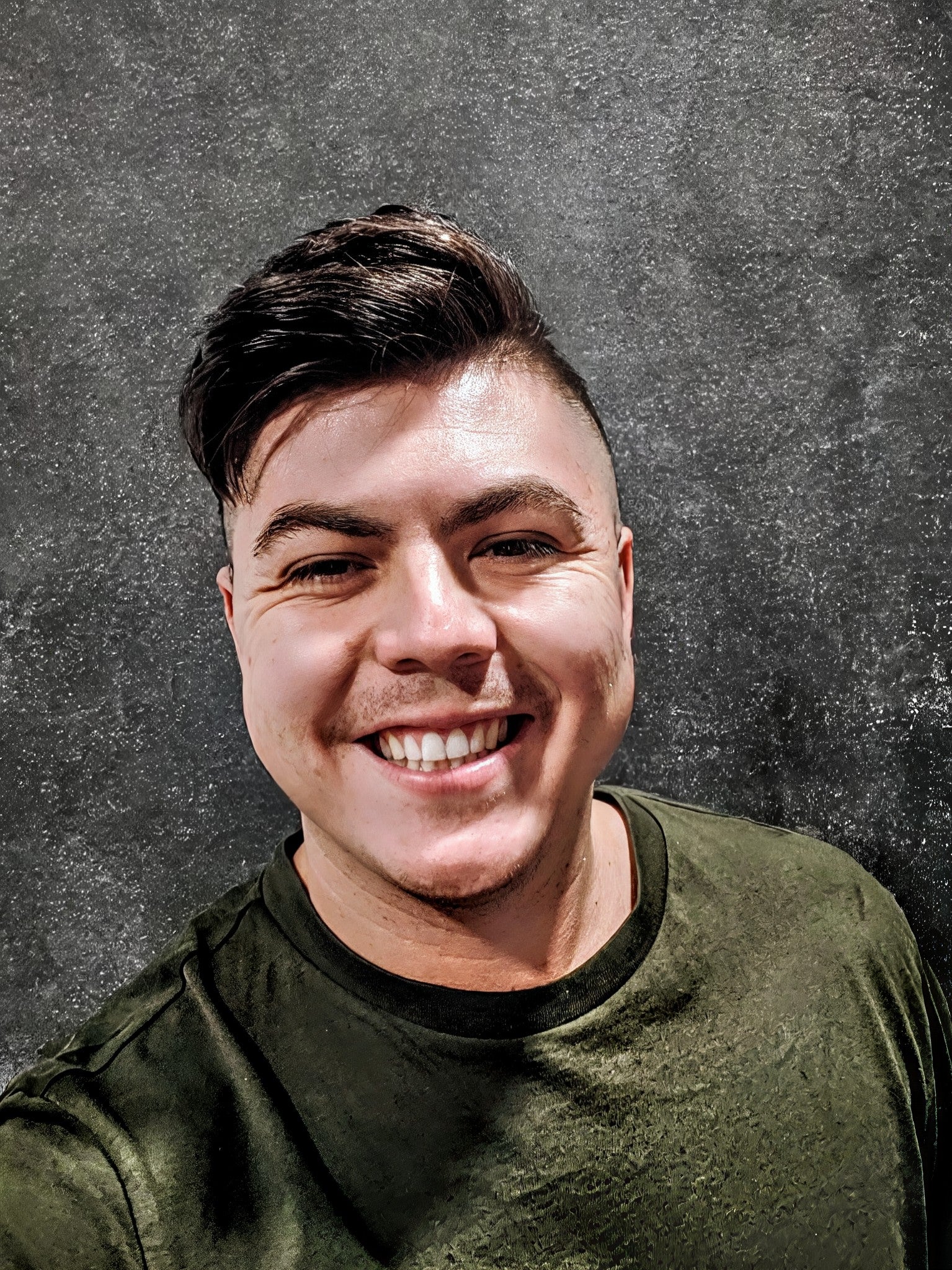 Ben Reeves- wearing green shirt against grey background